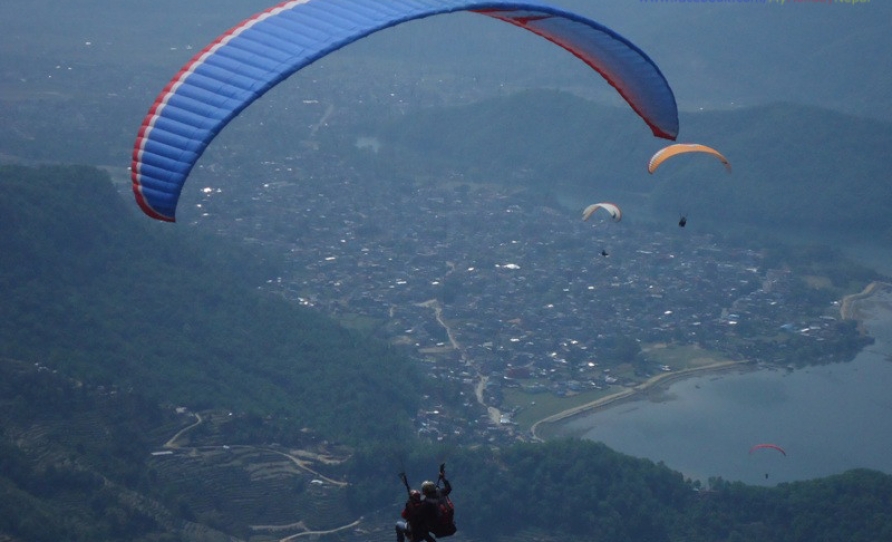 above the fewa lake paragliding